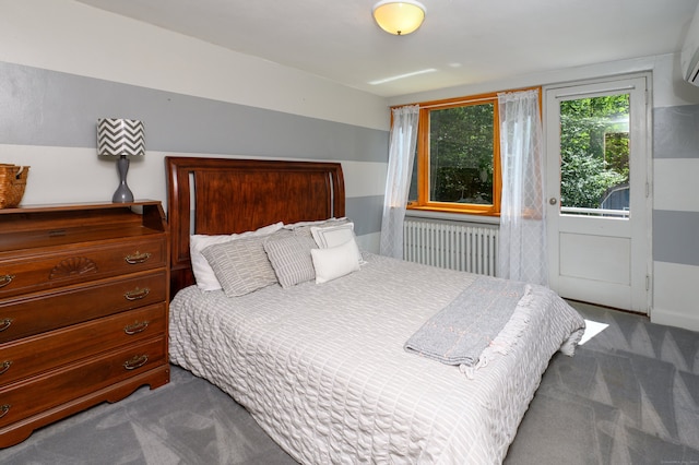 bedroom featuring radiator, a wall unit AC, and carpet