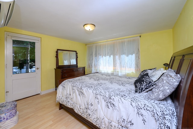 bedroom featuring multiple windows and hardwood / wood-style floors