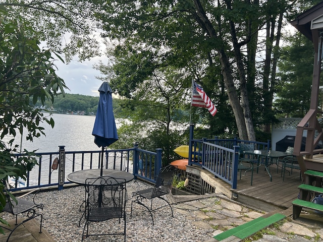 view of patio / terrace with a deck with water view