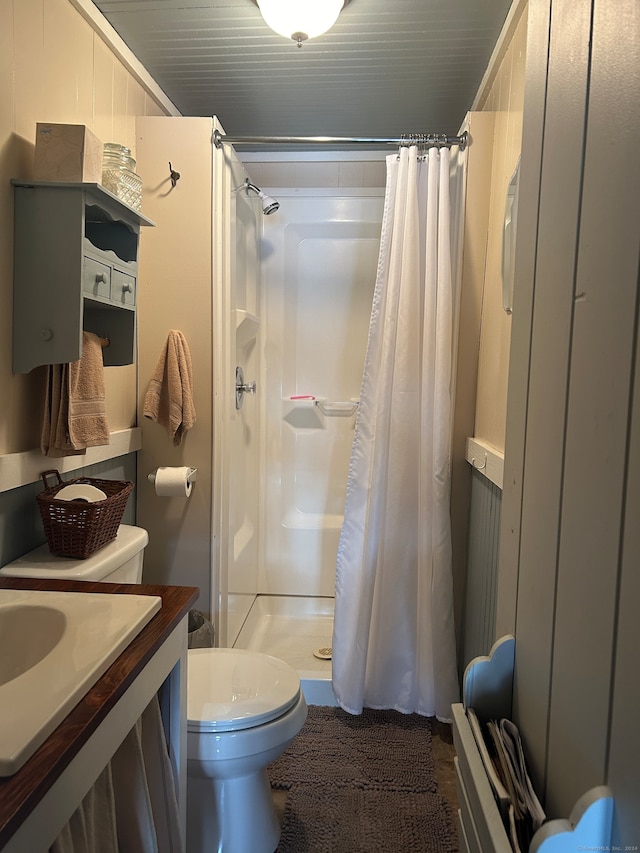 bathroom with curtained shower and toilet