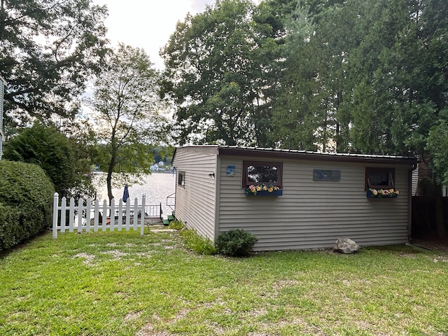 view of side of property with a yard