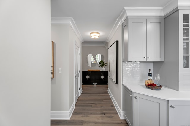 hallway featuring dark hardwood / wood-style flooring and crown molding