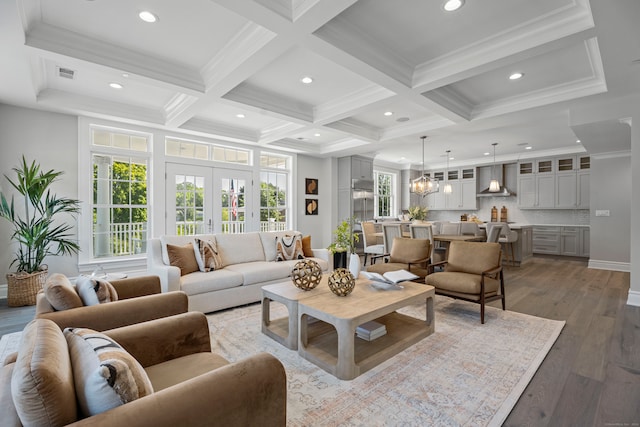 living room featuring coffered ceiling, crown molding, hardwood / wood-style flooring, and beam ceiling