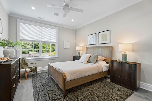 bedroom featuring ceiling fan, crown molding, and hardwood / wood-style flooring