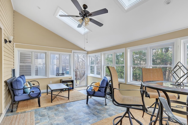 sunroom featuring vaulted ceiling with skylight and a ceiling fan