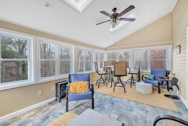 sunroom featuring vaulted ceiling with skylight and ceiling fan