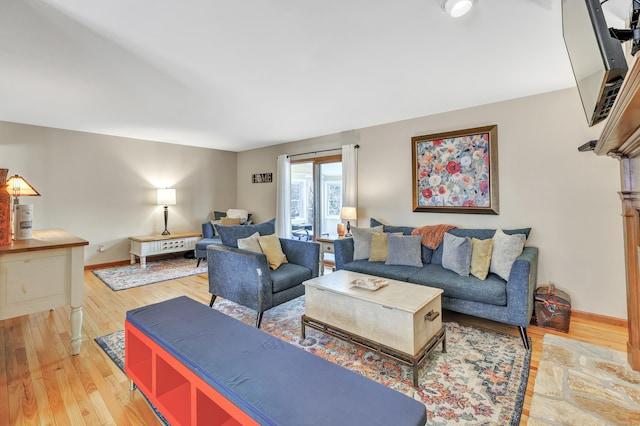 living room with baseboards and light wood finished floors