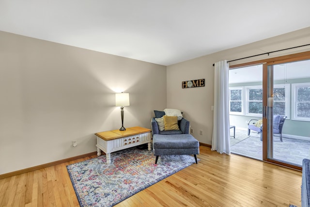 sitting room featuring light wood finished floors and baseboards