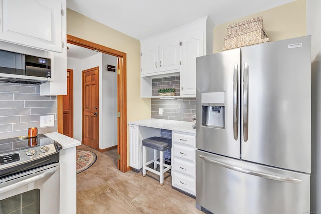 kitchen with decorative backsplash, appliances with stainless steel finishes, white cabinets, and light countertops