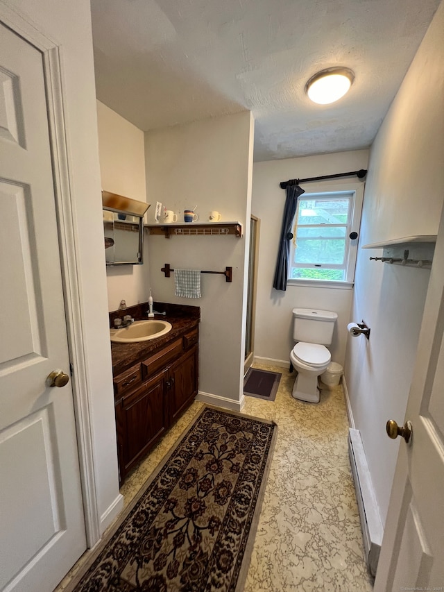 bathroom featuring a baseboard radiator, toilet, tile patterned floors, and vanity