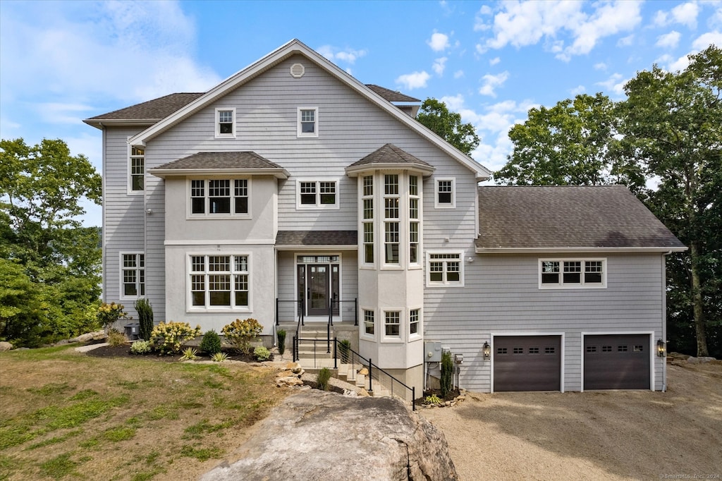 view of front of house with a garage and a front lawn