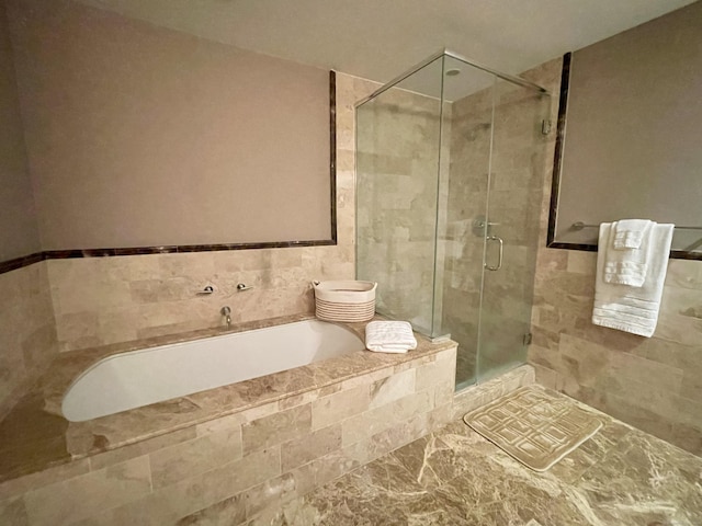 full bath featuring a shower stall and a bath