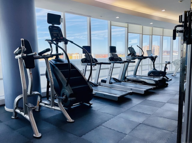 exercise room with expansive windows and recessed lighting