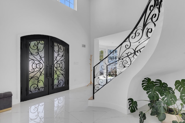 foyer entrance with french doors and a wealth of natural light