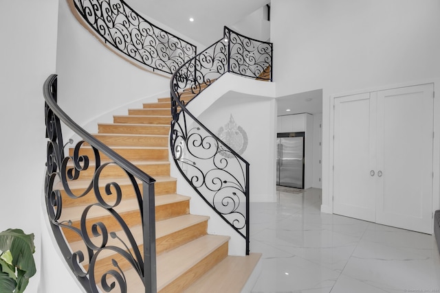 stairs featuring a towering ceiling