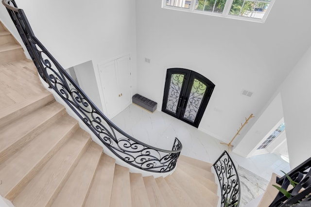 entryway featuring a towering ceiling