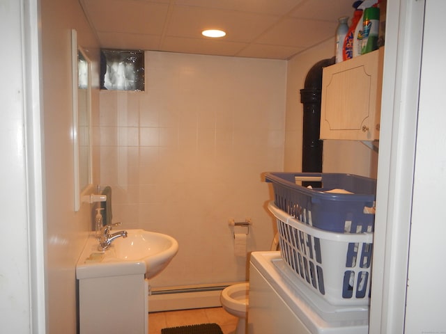 bathroom with toilet, tile patterned flooring, vanity, and a baseboard radiator