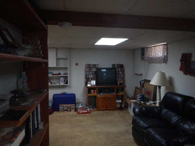 carpeted living room with a drop ceiling