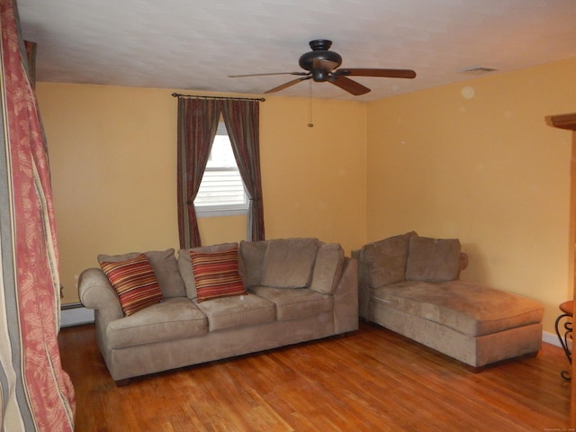 living room featuring hardwood / wood-style flooring, a baseboard radiator, and ceiling fan