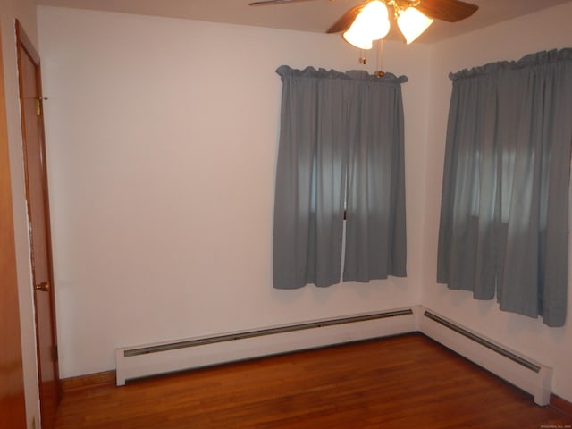 spare room featuring ceiling fan and dark wood-type flooring