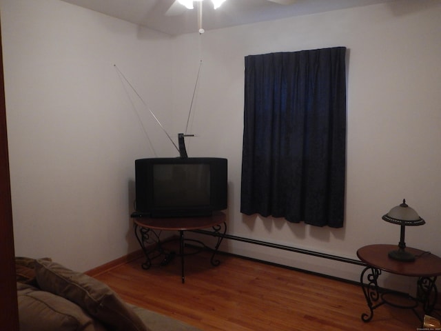 living area with ceiling fan and wood-type flooring