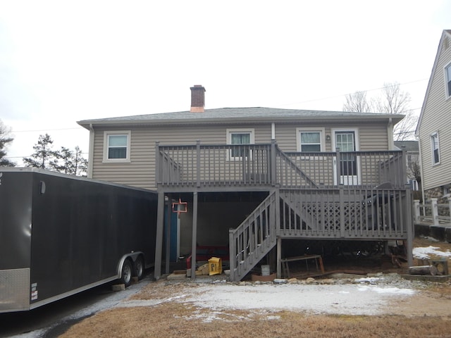 snow covered property with a wooden deck