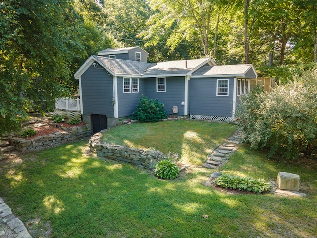 rear view of property with a lawn