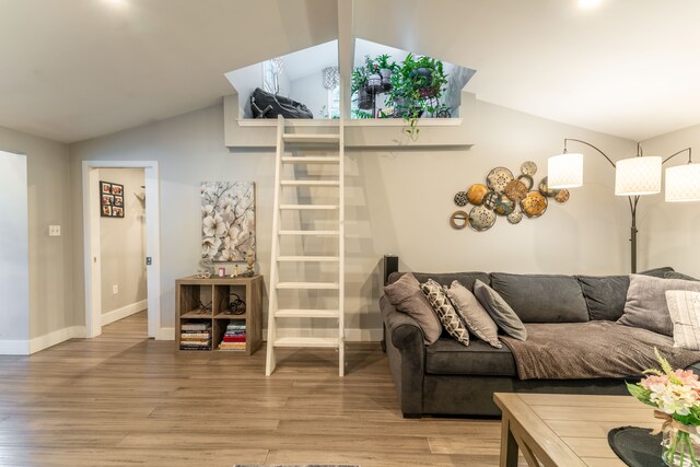 living room featuring light wood-type flooring and lofted ceiling