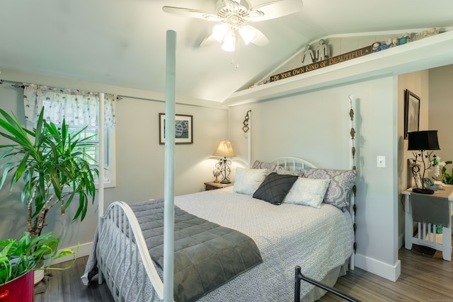 bedroom with ceiling fan, vaulted ceiling, and wood-type flooring