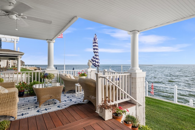 wooden deck featuring ceiling fan and a water view