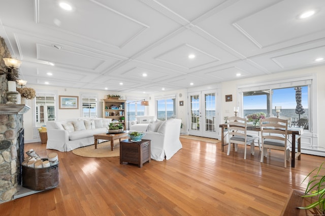 living room with light hardwood / wood-style floors, a fireplace, and coffered ceiling