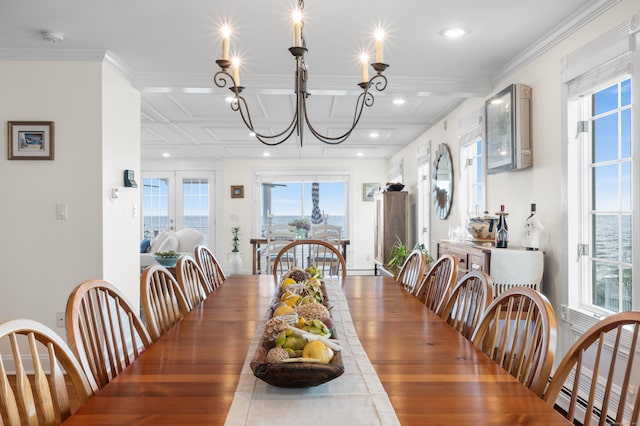 dining room featuring dark wood-type flooring, baseboard heating, a notable chandelier, and ornamental molding