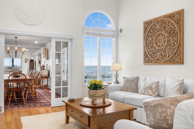 living room featuring a chandelier and light hardwood / wood-style floors