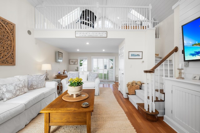 living room with a high ceiling and hardwood / wood-style floors