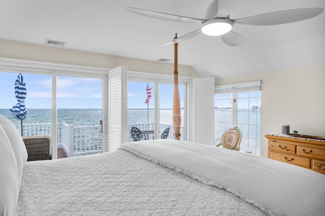 bedroom with multiple windows, access to outside, a water view, vaulted ceiling, and ceiling fan