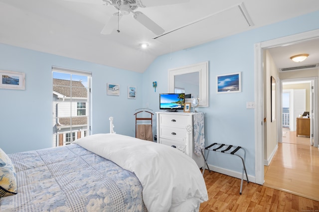 bedroom with vaulted ceiling, ceiling fan, and light hardwood / wood-style flooring