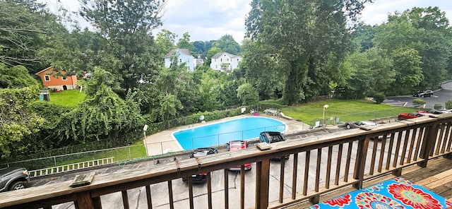 view of swimming pool with a lawn and a deck