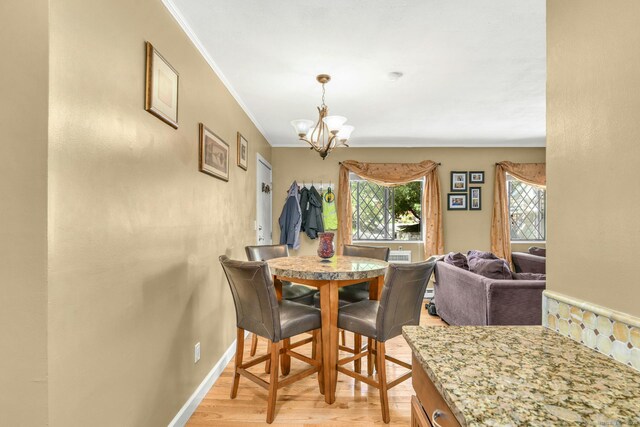 dining area featuring light hardwood / wood-style flooring and a chandelier