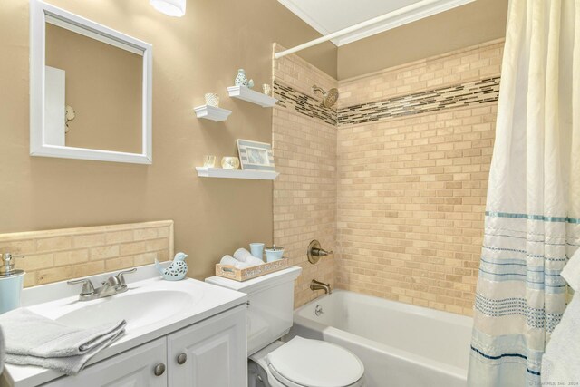 full bathroom with toilet, shower / bath combo with shower curtain, vanity, and ornamental molding