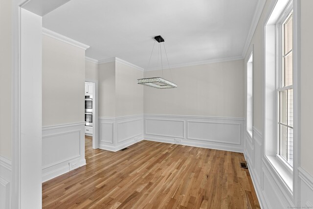 289 Young St, East Hampton, CT 06424 - unfurnished dining area featuring crown molding, plenty of natural light, visible vents, and light wood finished floors