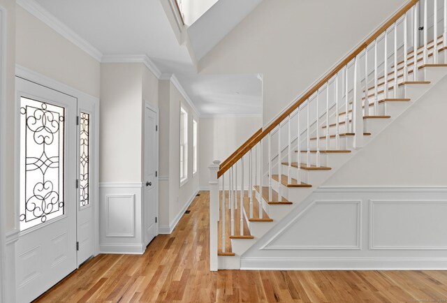 289 Young St, East Hampton, CT 06424 - entryway with plenty of natural light, wood finished floors, crown molding, and a decorative wall