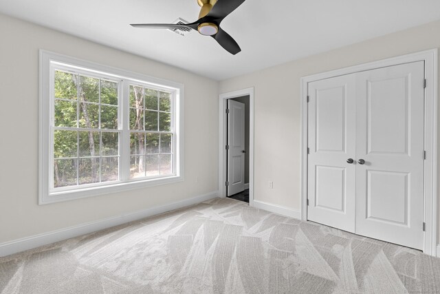 289 Young St, East Hampton, CT 06424 - unfurnished bedroom with a closet, light colored carpet, baseboards, and ceiling fan