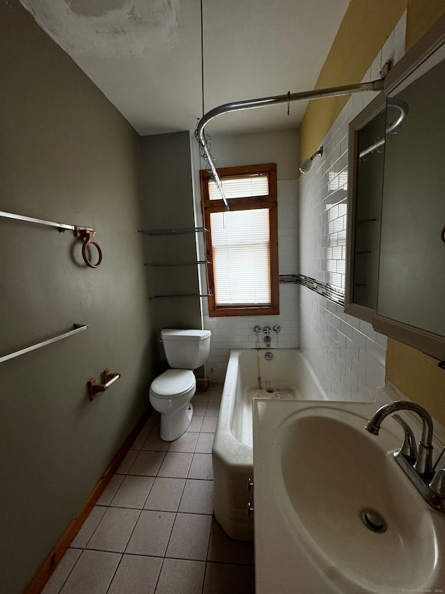 bathroom featuring toilet, tile walls, sink, and tile patterned flooring