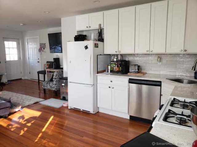 kitchen featuring white refrigerator, white cabinets, sink, stainless steel dishwasher, and dark hardwood / wood-style floors