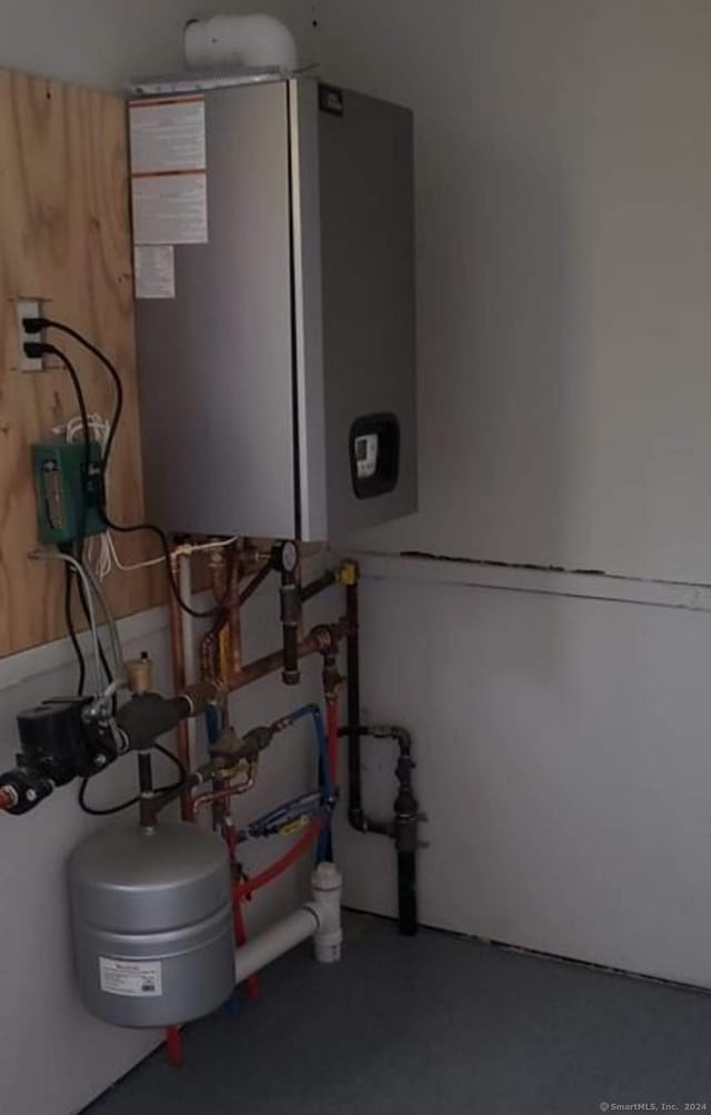 utility room featuring water heater