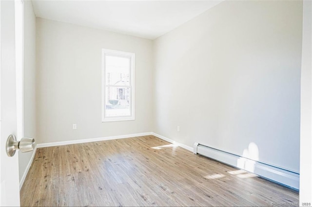 spare room with light hardwood / wood-style flooring and baseboard heating