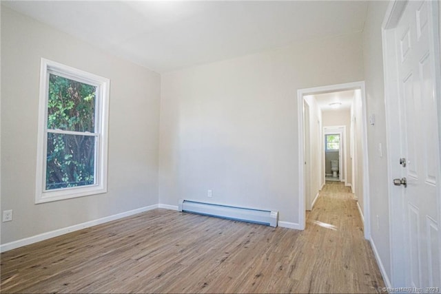 spare room featuring light hardwood / wood-style flooring and baseboard heating