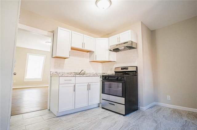 kitchen featuring backsplash, sink, light wood-type flooring, range, and white cabinetry