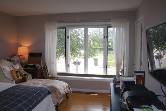 bedroom with baseboards and wood finished floors