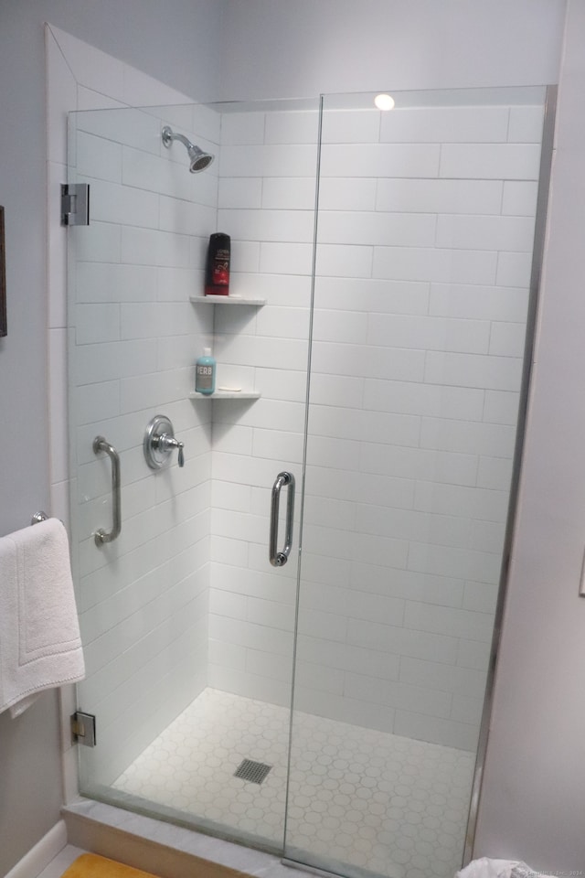 bathroom with a shower with shower door